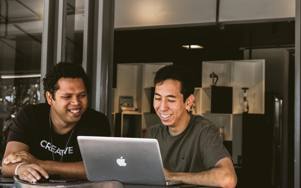 Two colleagues building and testing on a laptop
