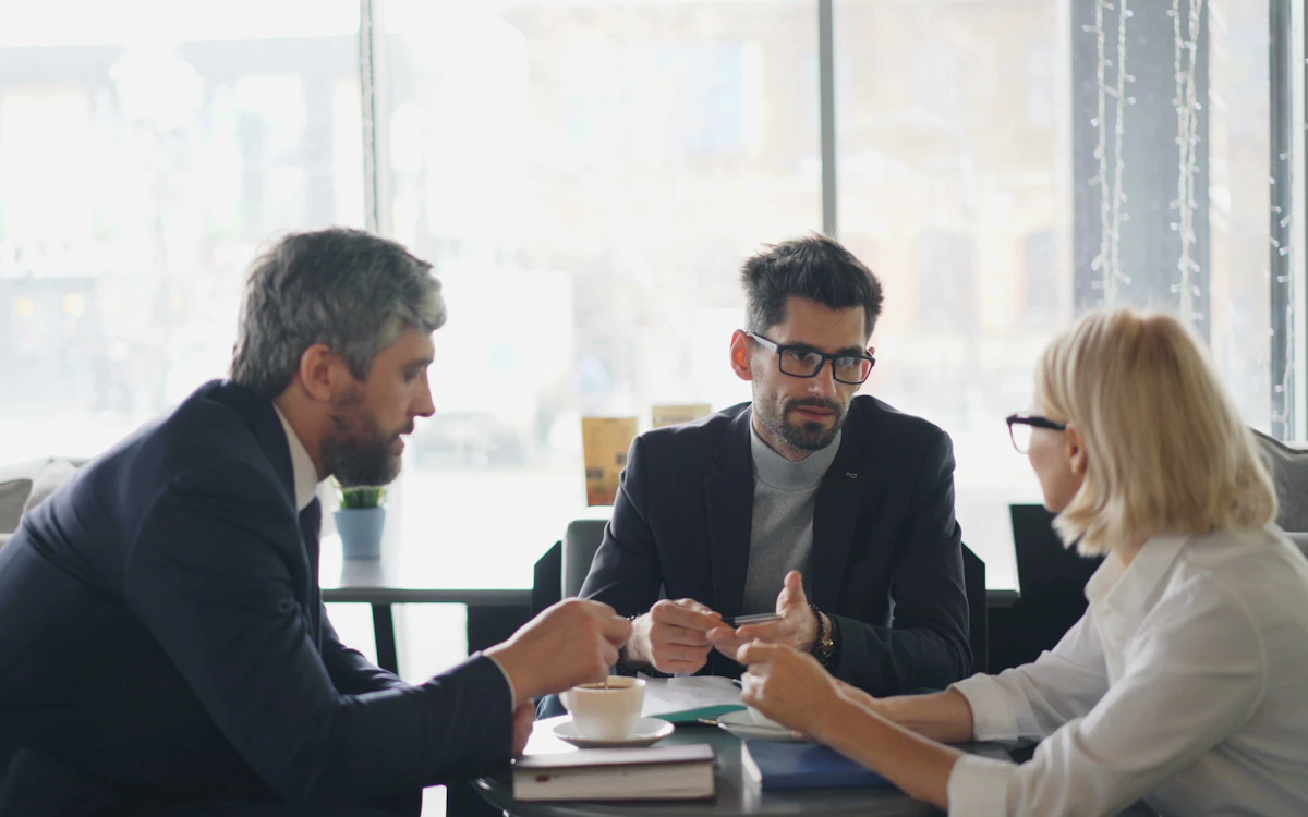 Three people reviewing results around a table